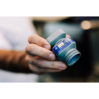 Hand holding MKN WaveClean two-in-one cleaning cartridge