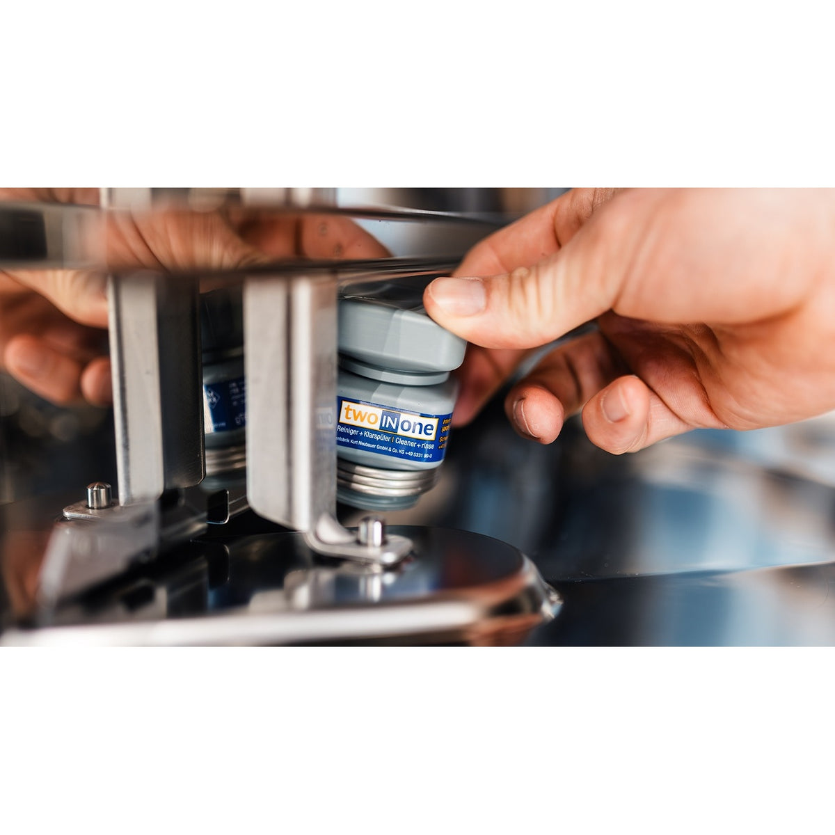 MKN WaveClean two-in-one cleaning cartridge being inserted into a combi oven WaveClean port